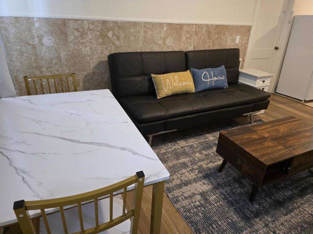a living room with a black couch and a table at Modern Victorian by Beach and Forest Unit D in Crescent City