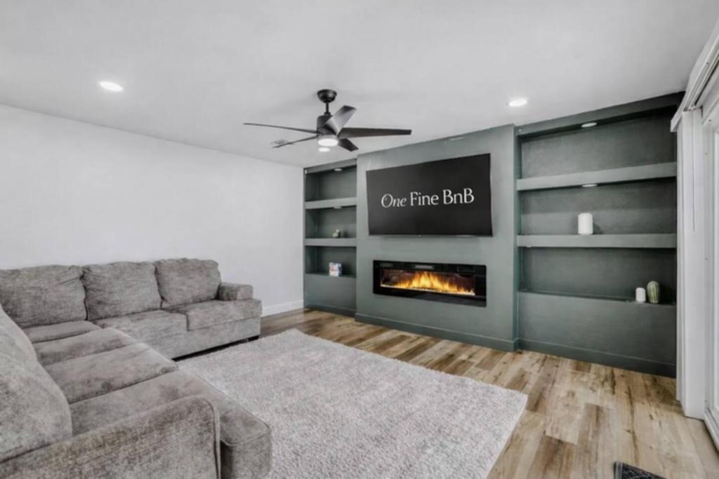 a living room with a couch and a fireplace at 4BR Mesa Basecamp, Mins to Cubs Spring Training in Mesa