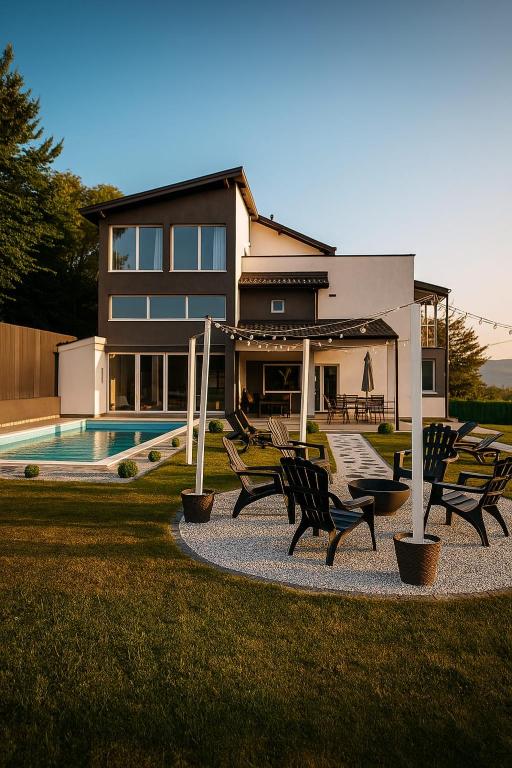 a house with a pool and chairs in front of it at Villa Kaplan Sarajevo in Gladno Polje