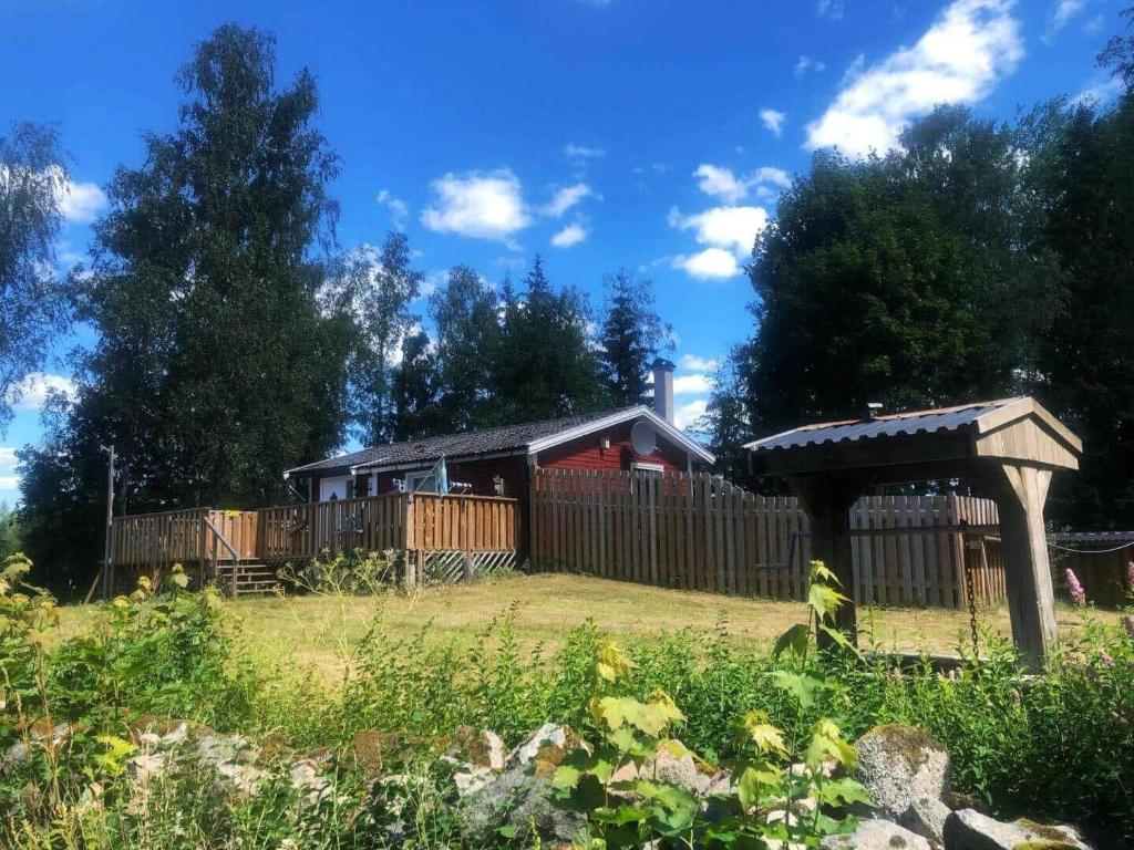 a house with a fence and a gazebo at BLE853-Holmsjoe-Aelmtamala-338 in Holmsjö