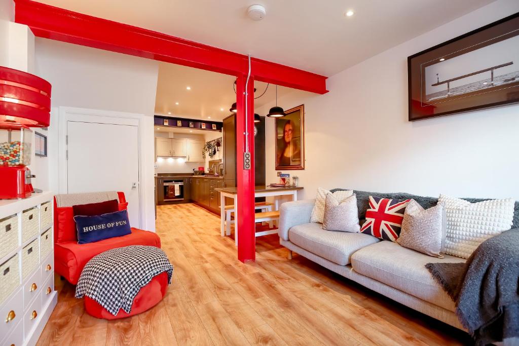 a living room with a couch and a red pole at The Simms Suite in Worthing