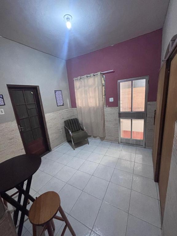 a living room with a couch and a chair at Pousada Mara Mar Niterói in Niterói