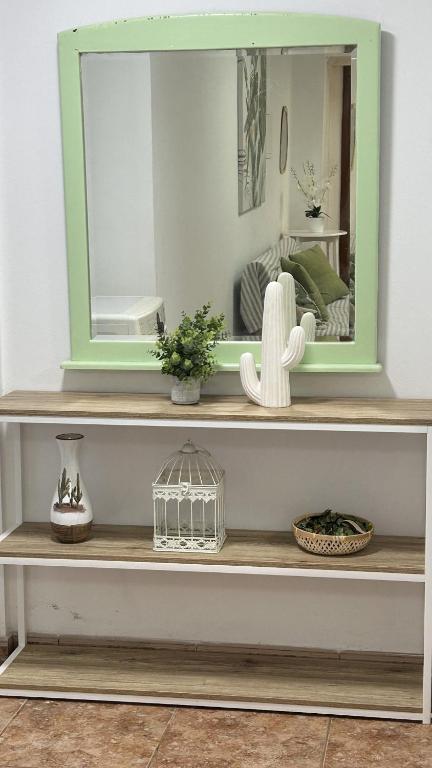 a mirror on top of a shelf in a room at Apartamento Caminho da Praia in Pedro Miguel