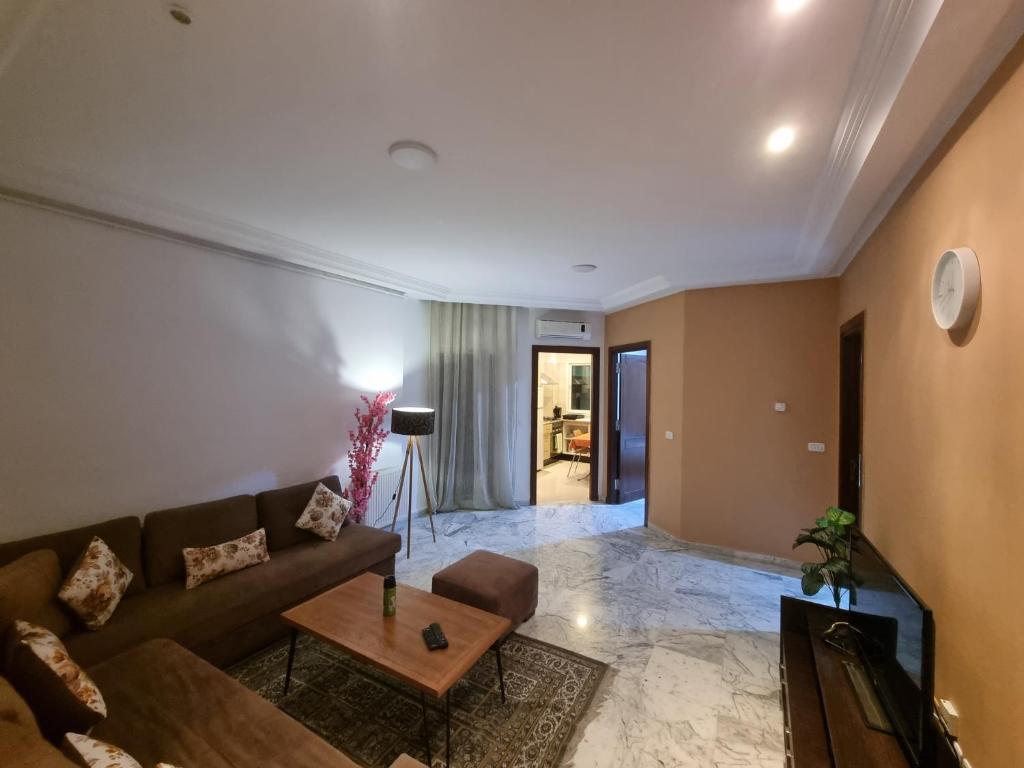 a living room with a couch and a table at Luxe studio tunisia mall lac 2 in Tunis