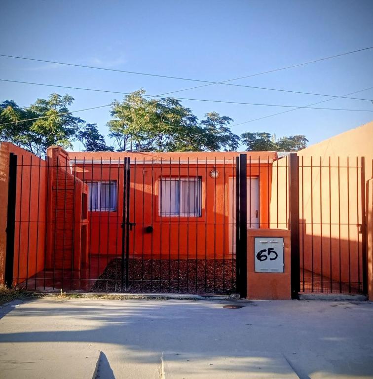 an orange fence in front of a building at Dpto en San Antonio Oeste 3 pax in San Antonio Oeste