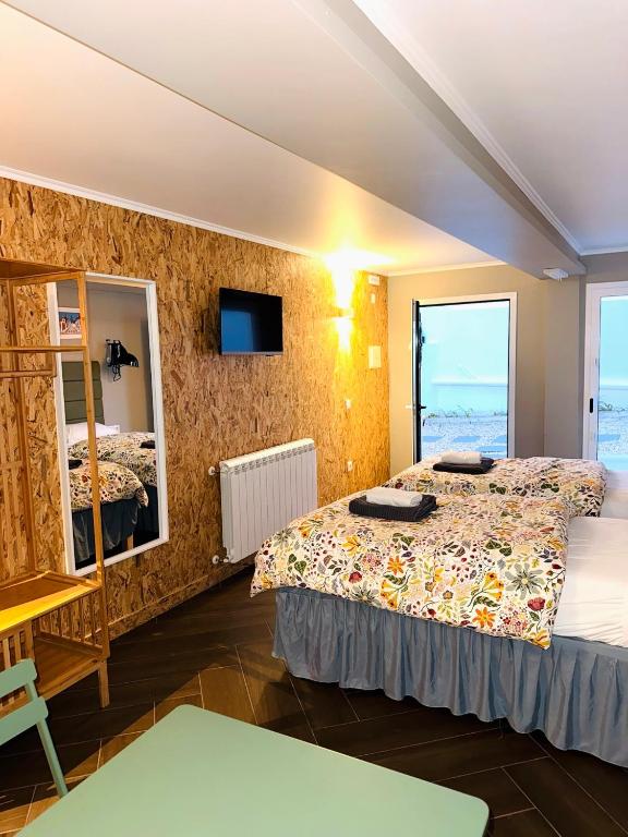 a hotel room with two beds and a window at Studio LEIRIA Side in Leiria