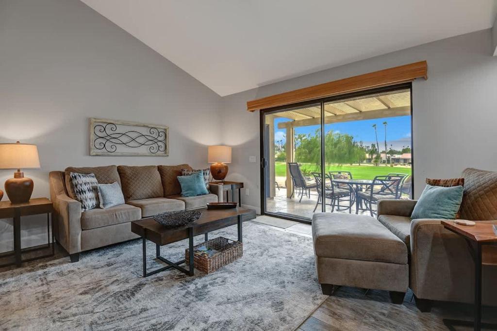 a living room with a couch and a table at PL645 - Bay Hill Fairway - Alice Lodging in Palm Desert