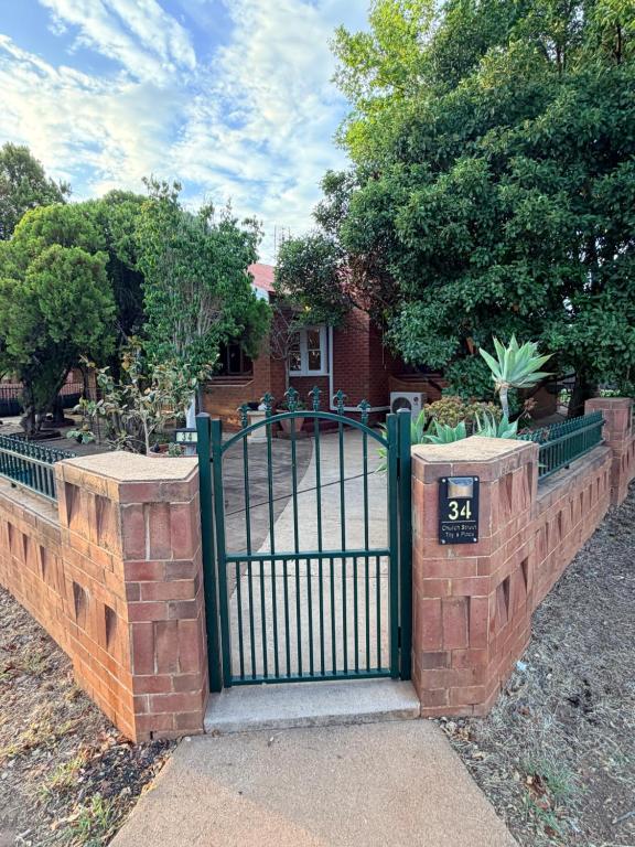 a gate in front of a house with a house at Tily's Place in Parkes