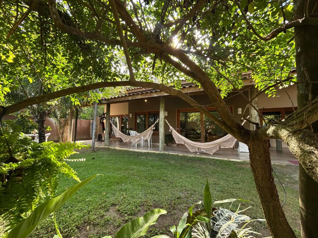 a house with hammocks in the yard at Casa das Alpinias - Trancoso in Trancoso