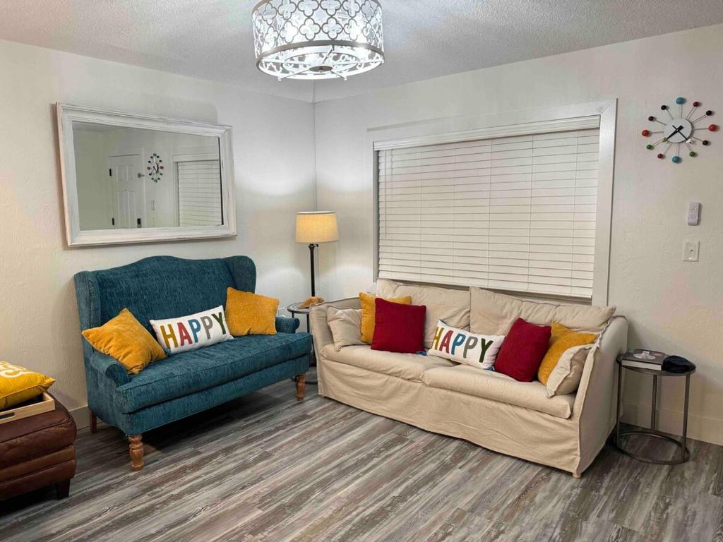 a living room with a couch and a blue chair at Mid-Century Modern Beachfront in Flagler Beach