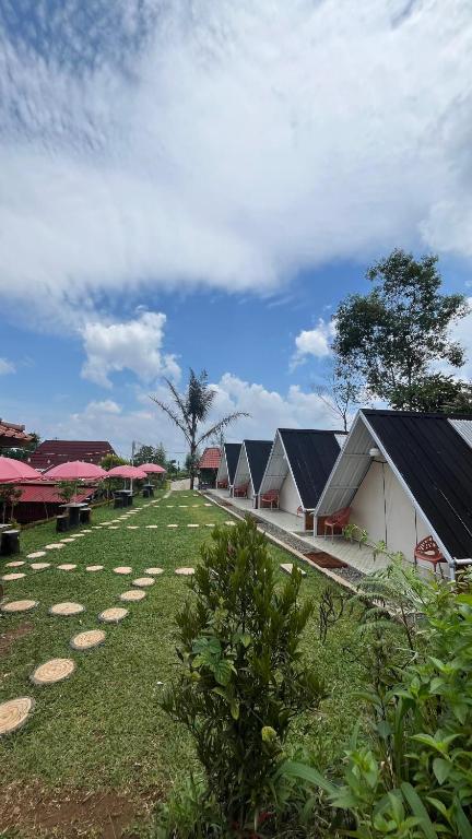a row of white buildings with red roofs at camping camp modern in Ciater