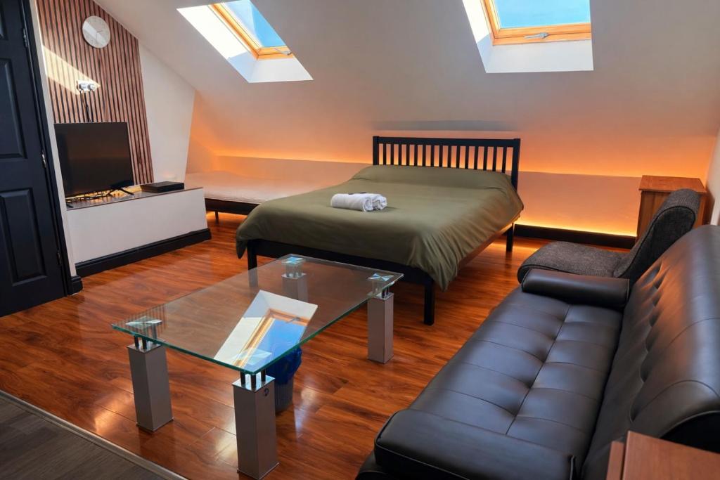 a living room with a bed and a couch at Tarleton house in Stoke on Trent