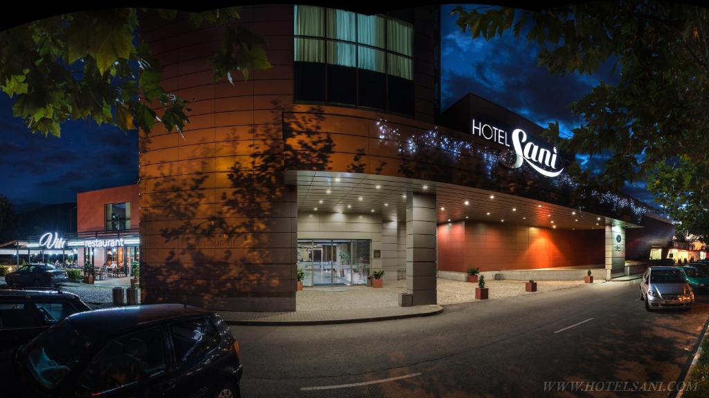 a building with a hot sun sign on it at Hotel Sani in Asenovgrad