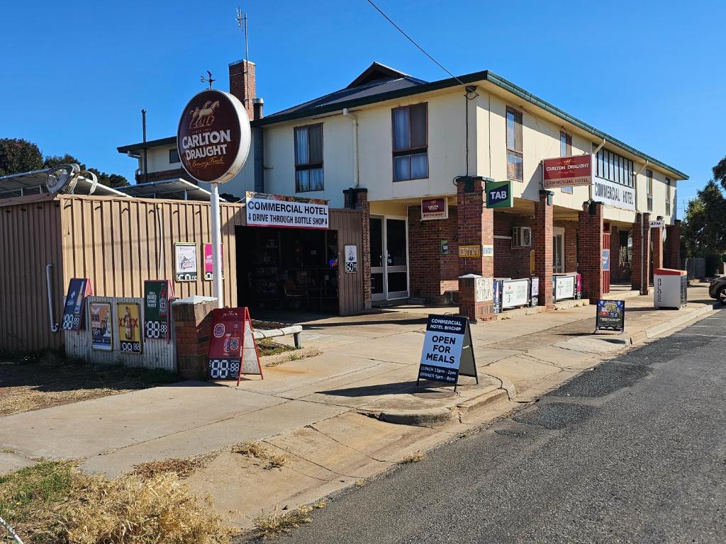 a street with signs in front of a building at Commercial Hotel in Birchip