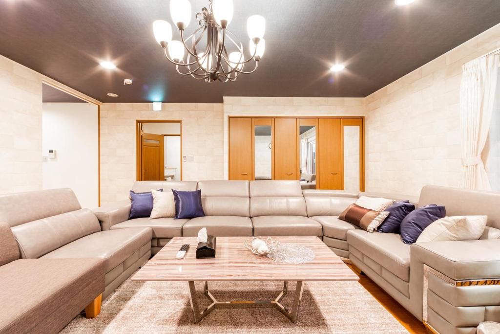 a living room with a couch and a table at THE WORLDWIDE HOUSE in Sapporo