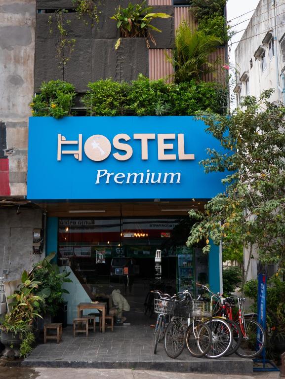 a sign for a restaurant with bikes parked in front at TT Premium Hostel Vientiane in Vientiane