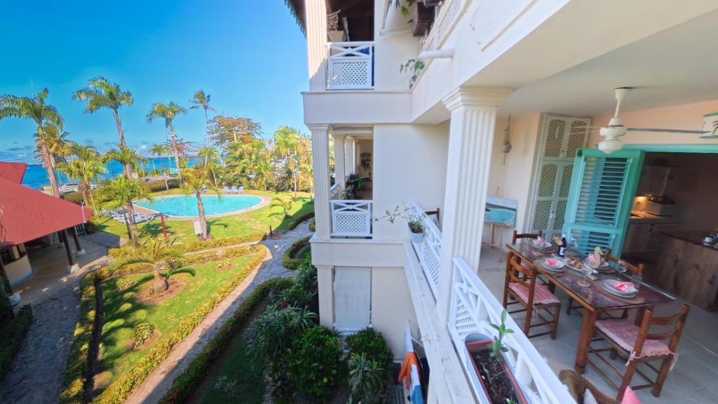a view from the balcony of a house with a table at La Dolce Vita Beachfront Apt 9 in Las Terrenas