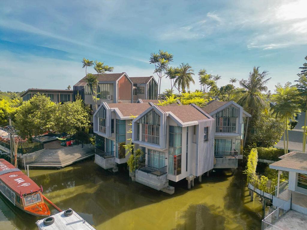 an aerial view of a house in the water at W1Bangkoknoi Hotel in Nonthaburi