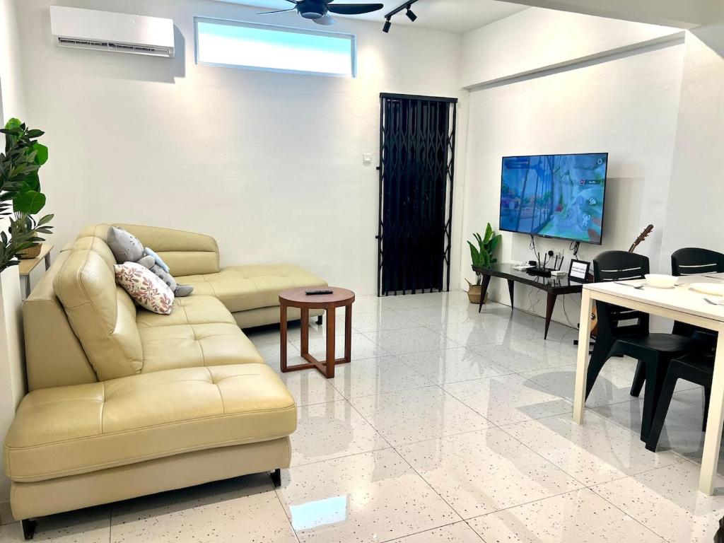 a living room with a couch and a table at Casa for 8 ipoh Central Pet Allowed in Ipoh