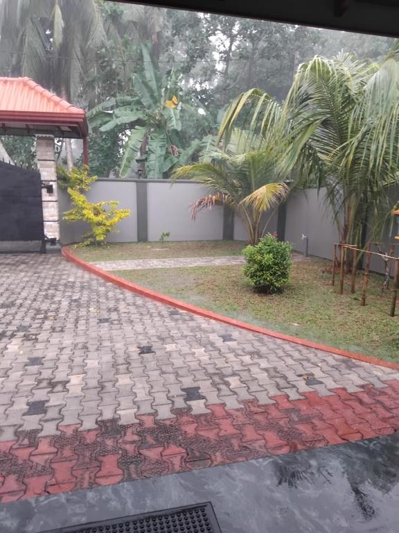 a red hose on the ground in front of a house at SAS Villa in Ahungalla
