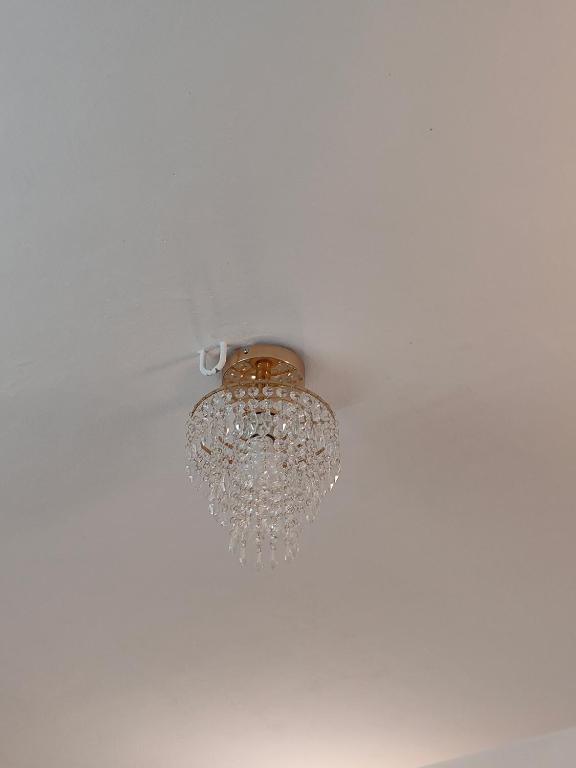 a chandelier hanging from the ceiling of a room at Ivory Suites in Kozhikode