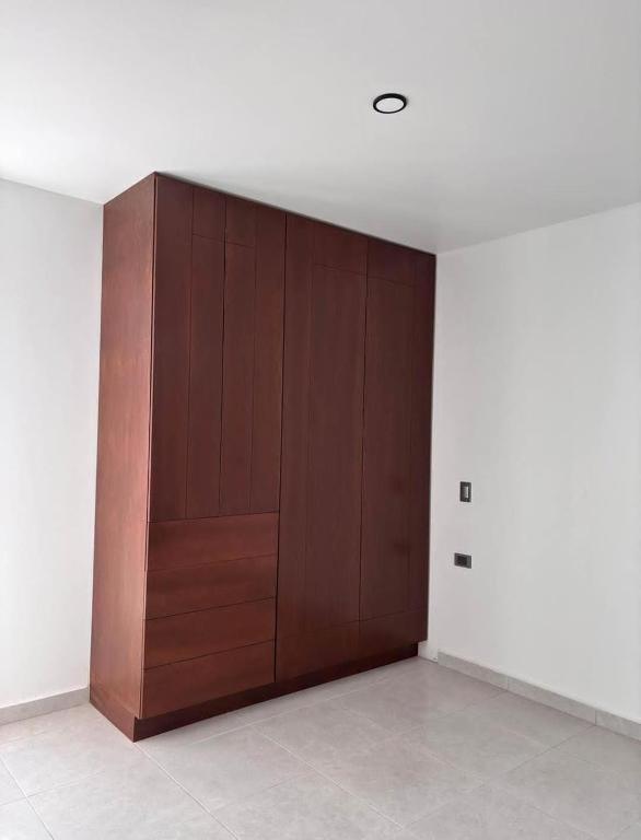 a large wooden door in a room with a wall at Departamento lao in Santa Cruz