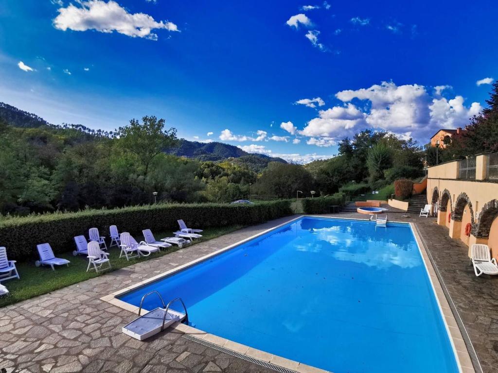 a pool at a villa with mountains in the background at Casa Melabruna, 5 terre biker friendly in Pignone