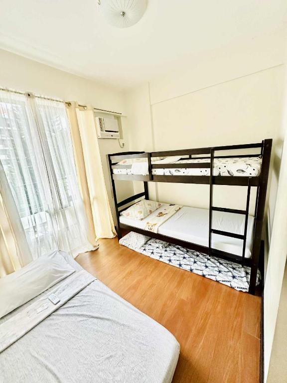 a bedroom with a bunk bed and a wooden floor at THE PRECIOUS TIME LOUNGe in Davao City