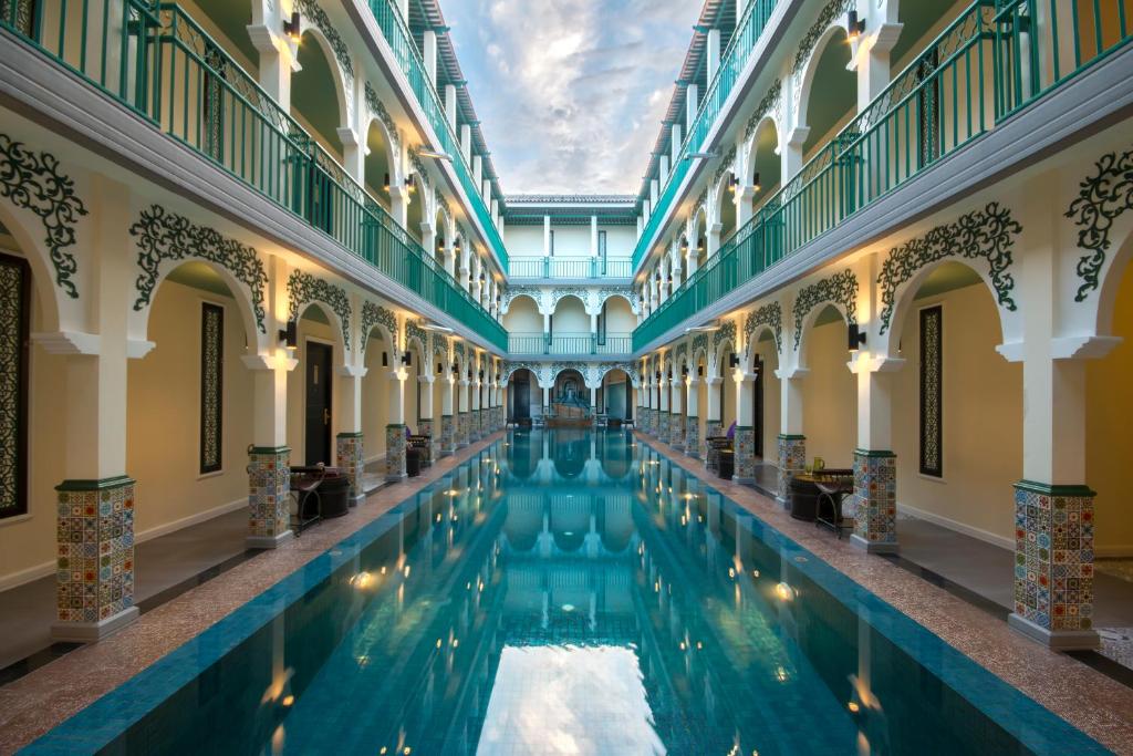 una piscina coperta in un edificio con soffitto di Palette The Grand Morocc Hotel a Mae Rim