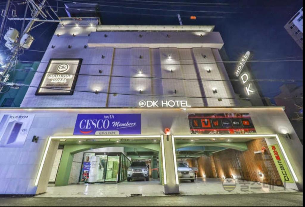 a building with a car garage at night at DK hotel in Incheon