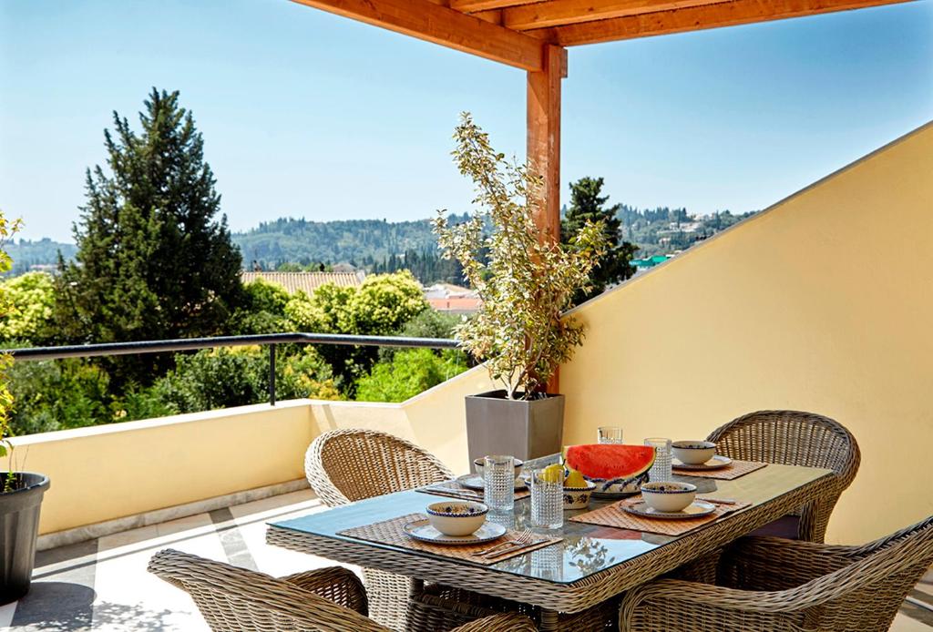 a table and chairs on a balcony with a view at Helion Apartments - Parallel in Gouvia