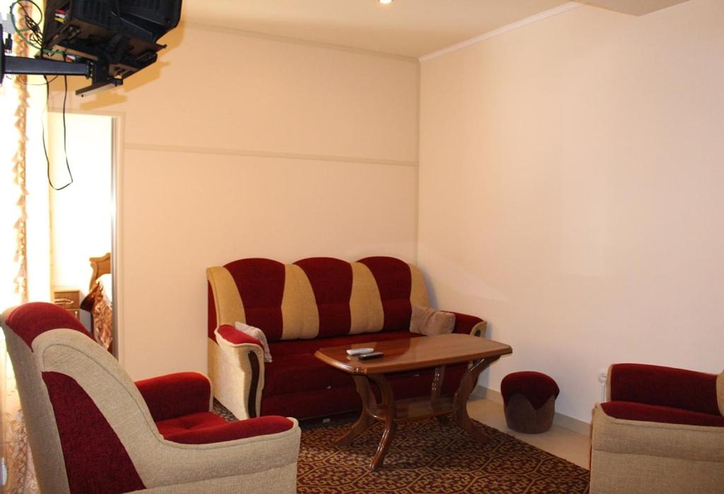 a waiting room with a couch and chairs at Shushanik Home in Jermuk