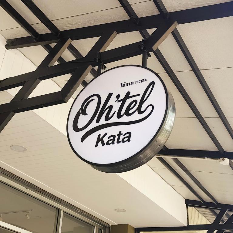 a sign hanging from the ceiling of a restaurant at Oh'tel Kata in Kata Beach