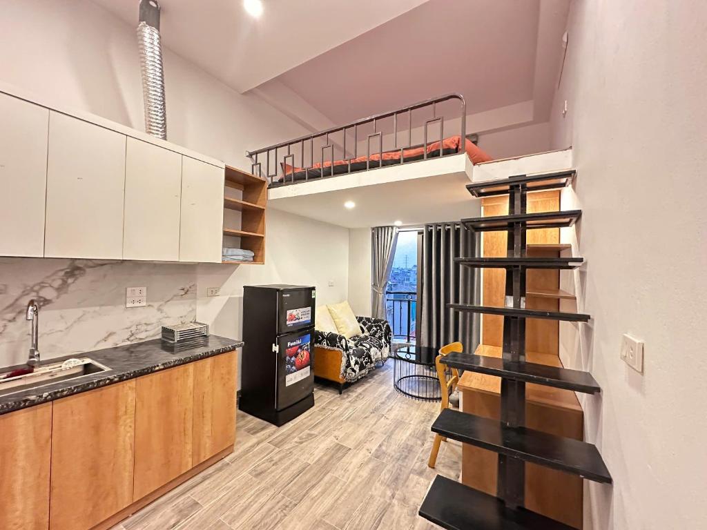 a kitchen with a loft bed and a spiral staircase at Urban Nest - Đông Ngạc in Hanoi