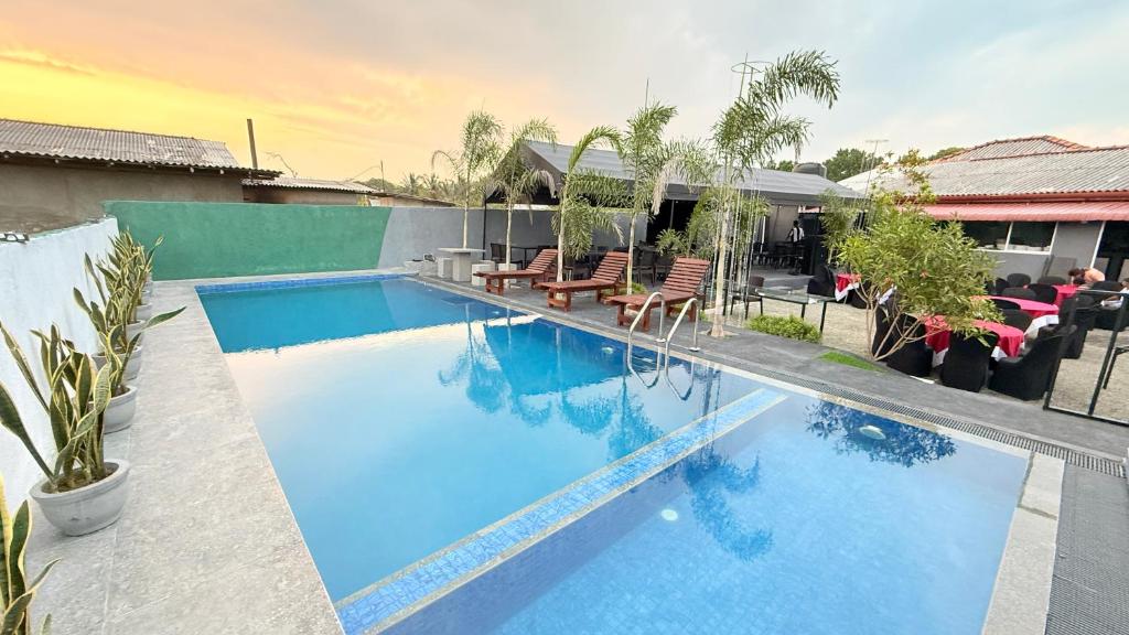 a swimming pool with blue water in a house at Sunset Villa in Hambantota