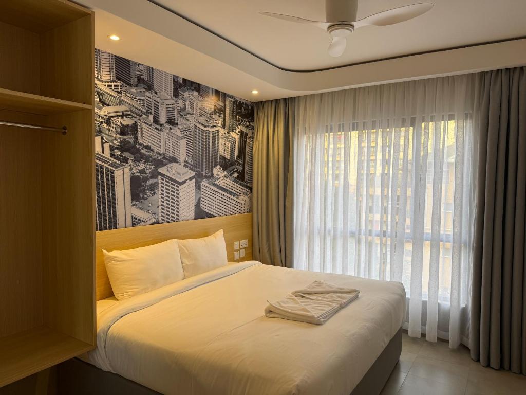 a bedroom with a bed with a black and white picture at Kozi - Wilson Airport in Nairobi