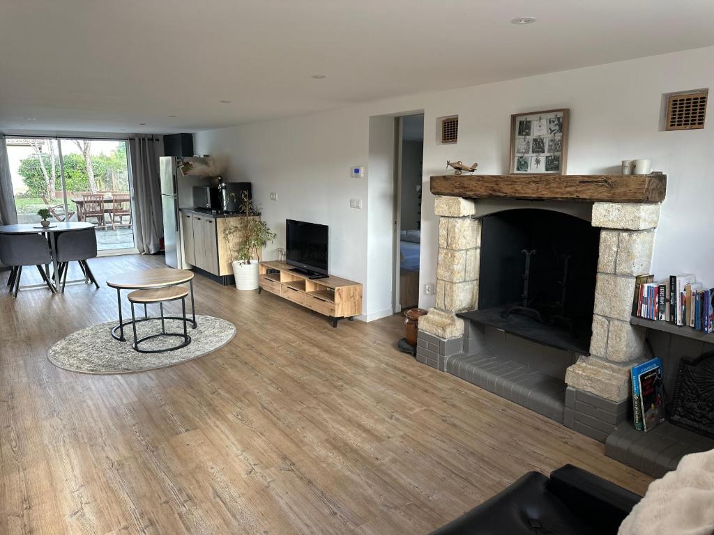 a living room with a fireplace and a table at Gîte familial Gers 12 pers in Fleurance