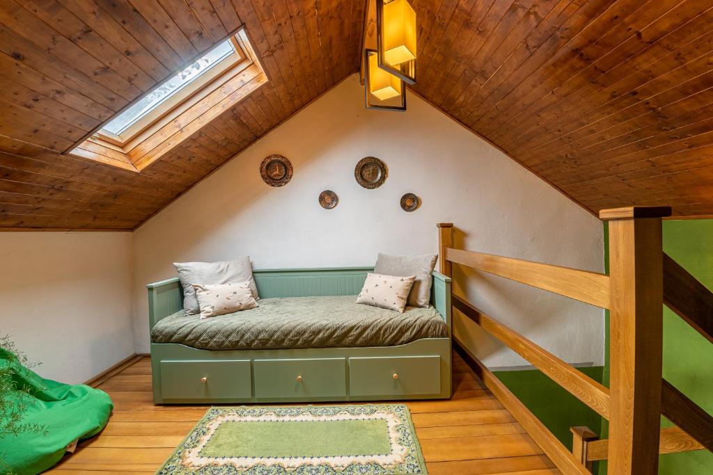 a bedroom with a bed in a attic at Grandma’s Cottage in Săcele