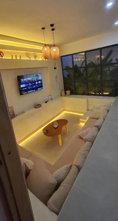 a living room with a couch and a table at Villa Moja in Nungwi