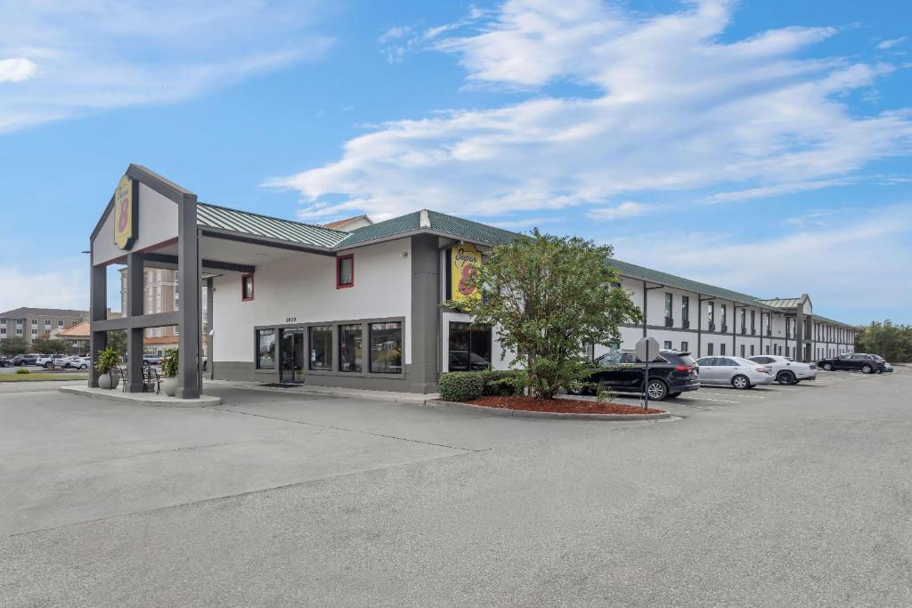 a building with a parking lot in front of it at Super 8 by Wyndham Valdosta GA I-75 in Valdosta