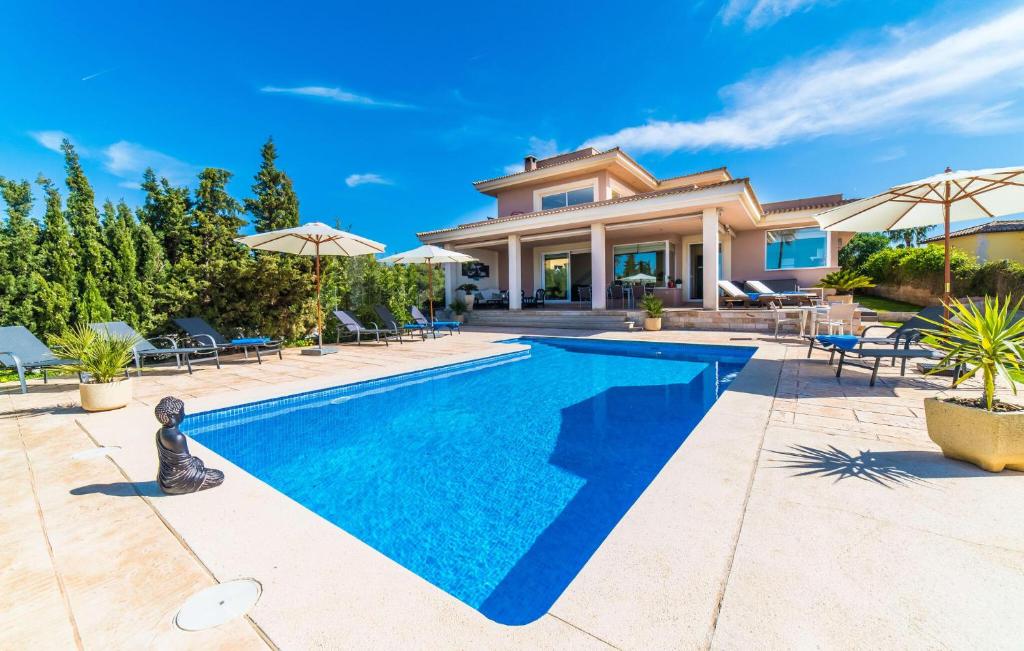 a villa with a swimming pool and a house at Redrema in Llucmajor