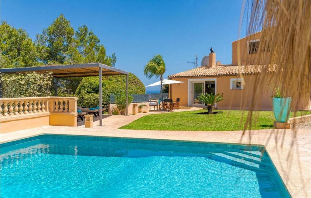 a swimming pool in front of a house at Es Socorrat in Portocolom