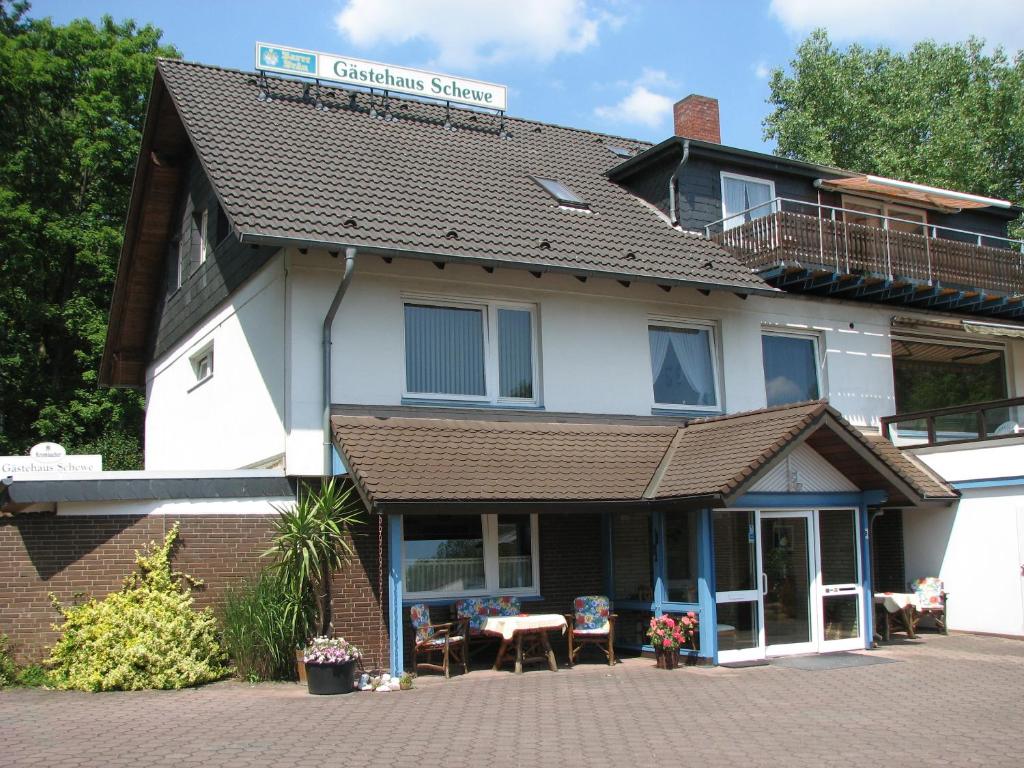 a building with a sign on top of it at Gästehaus Schewe in Ahnsen