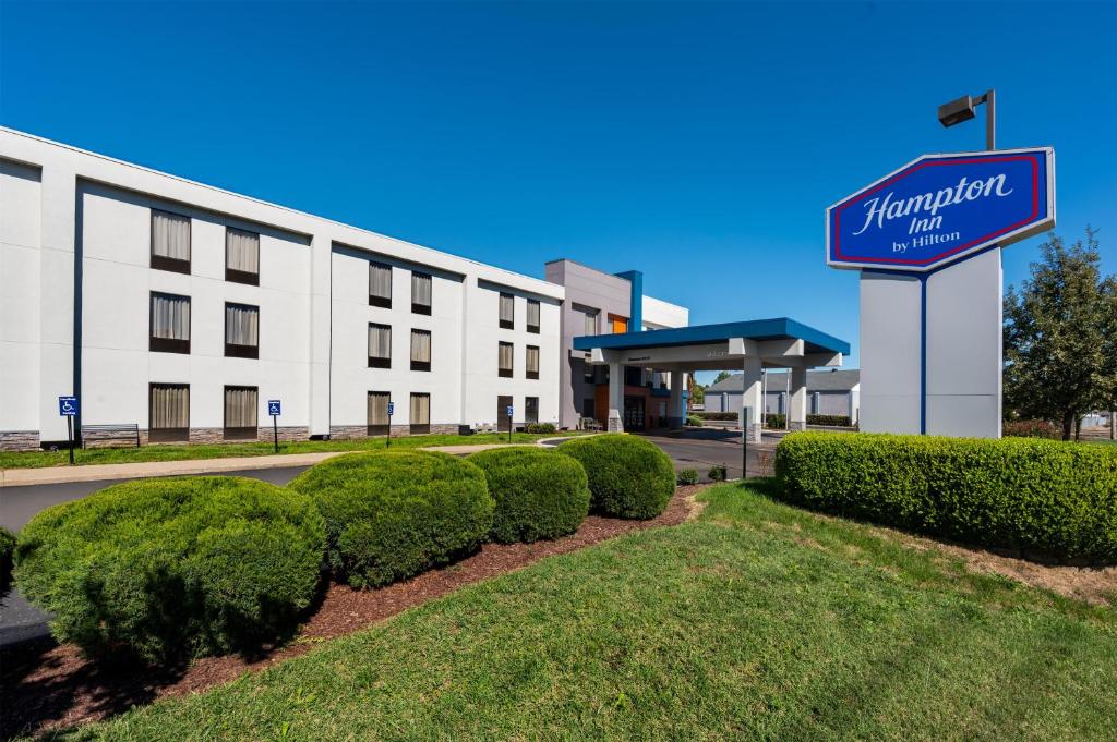 a hotel with a sign in front of a building at Hampton Inn Owensboro in Owensboro