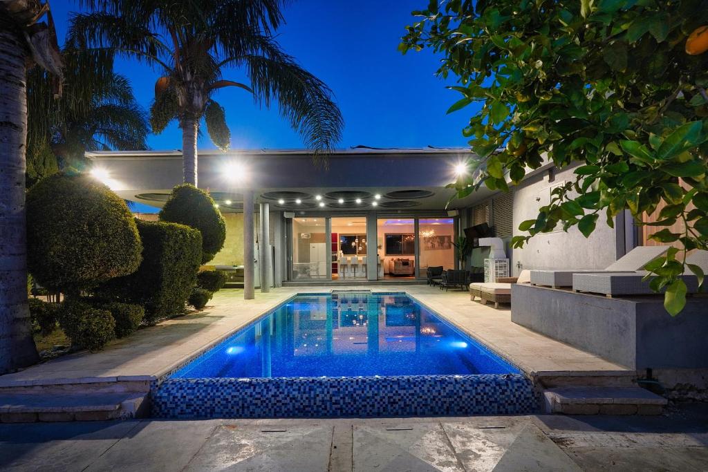 a swimming pool in the backyard of a house at S Villa Place נהריה in Nahariyya