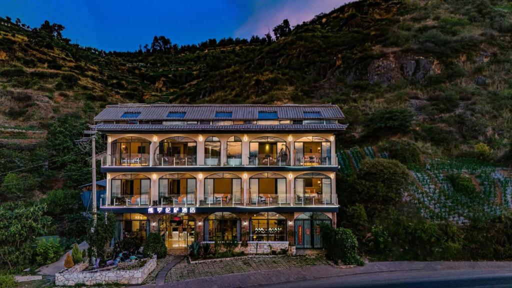 a large house with a mountain in the background at Jade moon in Dali