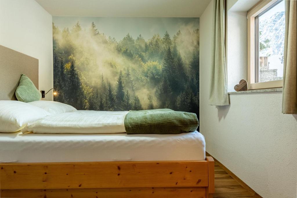 a bedroom with a large painting on the wall at Karwendelnest in Maurach