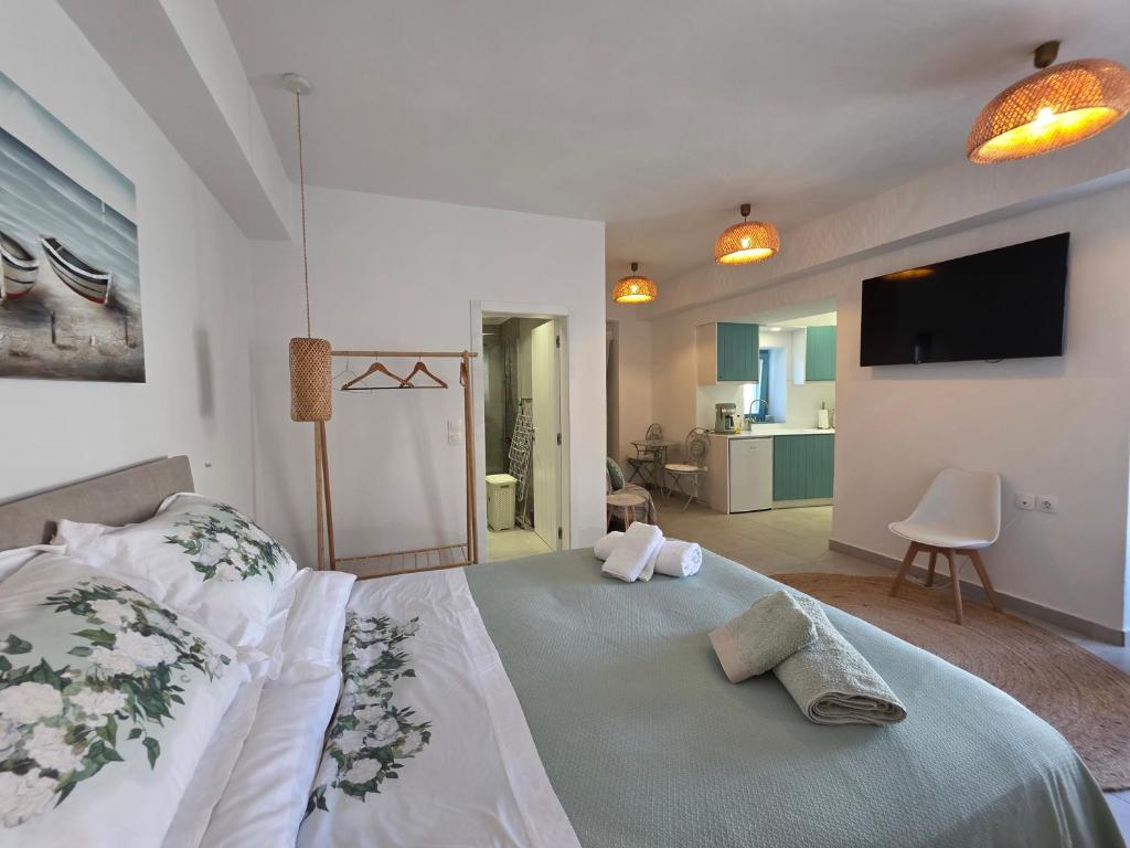 a bedroom with a large bed with a flat screen tv at Akti luxury aparts in Frý