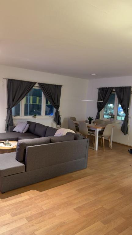 a living room with a couch and a table at Kirkenes down town apartments in Kirkenes