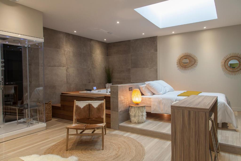 um quarto com uma cama e uma casa de banho com uma banheira em My Spa em Reims